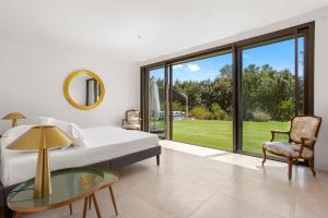 a bedroom with a bed and a glass table at Villa Valériane in Trans-en-Provence +32 photos