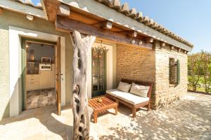 a patio with a couch and a table at Mini Country House in Sidari