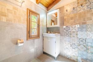a bathroom with a sink and a mirror at Mini Country House in Sidari +19 photos