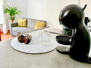 a kitchen counter with a toaster and glasses on a table at Apartamento centro 1-B in Huelva