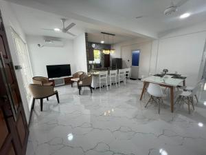 a living room with a table and chairs and a kitchen at Luxe Mini-Suite Maharagama in Maharagama