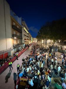 a large crowd of people sitting on a street at night at Apartamento centro 1-B in Huelva +1 photo