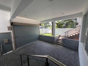 an empty garage with closed garage doors and stairs at Luxe Mini-Suite Maharagama in Maharagama