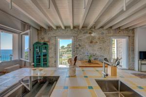 a kitchen with a view of the ocean at Casa Azzurrina Mare in Seccheto
