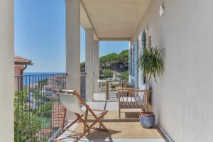 a balcony with two chairs and a table at Casa Azzurrina Mare in Seccheto