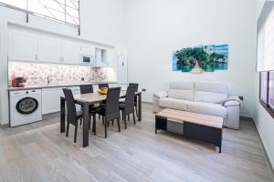 a kitchen and living room with a table and chairs at Ocean Suites A5 in Isla Cristina