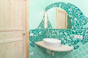 a bathroom with a sink and a mirror at Mavi Primo Piano in Palau +17 photos