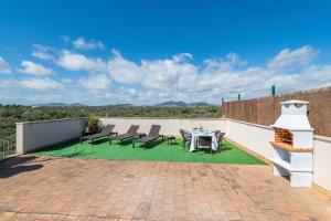 a patio with a table and chairs on a roof at Ferrera Soul 2b in Felanitx