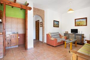 a living room with a couch and a tv at Casa Mora - Vejer, El Palmar in Vejer de la Frontera