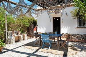 a blue table and chairs in front of a house at Casa Mora - Vejer, El Palmar in Vejer de la Frontera