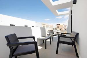 a row of chairs sitting on top of a balcony at Las Cuestitas Relax in Pájara +15 photos