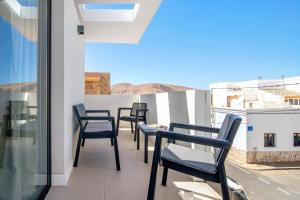 a row of chairs on a balcony with a view at Las Cuestitas Relax in Pájara