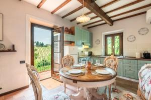 a kitchen with a wooden table and chairs and a table at Pietraserena - San Gimignano in San Gimignano
