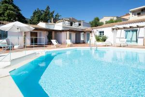 a swimming pool in front of a villa at Charming house in San Pantaleo in Olbia
