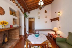 a living room with a table and a fireplace at Agriturismo Il Badalo in Riparbella
