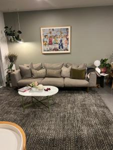a living room with a couch and a table at Albert Park Haven in Melbourne
