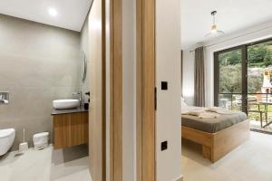 a bedroom with a bed and a bathroom at Sokol stone house in Vlikhón +59 photos