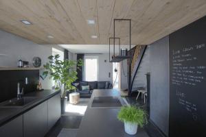a kitchen with a table and a chalkboard on the wall at Alb - Lotte in Bitz