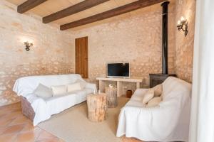 a living room with two white couches and a tv at Son Rossinyol Nou - 12 personas in Islas Baleares