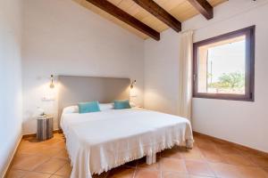 a bedroom with a large white bed with a window at Son Rossinyol Nou - 12 personas in Islas Baleares +31 photos
