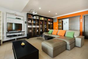 a living room with a couch and a tv at Las Perseidas in Costa Teguise