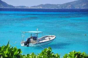 a boat sitting in the middle of the water at Tokashiku Marine Villege in Tokashiki