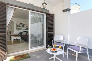 a patio with two chairs and a table at Villa Karon in Almancil