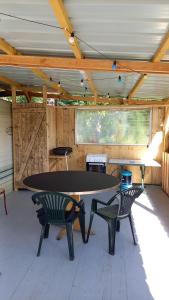 a ping pong table in a room with two chairs at Camping Sainte-Jalle in Sainte-Jalle