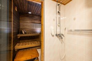 a bathroom with a shower and a walk in shower at Santa's Hotel Tunturi in Saariselka +117 photos