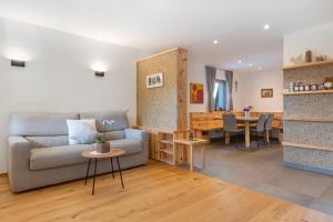 a living room with a couch and a table at Ferienhaus Tholer Hof in San Genesio Atesino