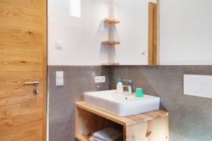 a bathroom with a white sink and a mirror at Ferienhaus Tholer Hof in San Genesio Atesino +31 photos