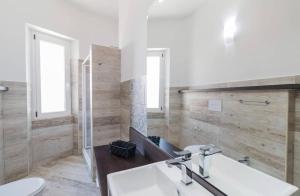 a bathroom with a sink and a toilet at Appartamento Castula in Dorgali