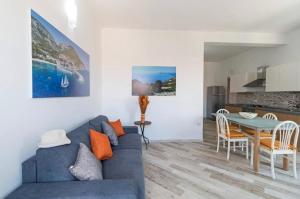 a living room with a blue couch and a table at Appartamento Castula in Dorgali
