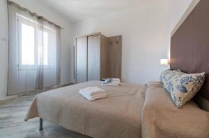 a bedroom with a large bed and a window at Appartamento Castula in Dorgali