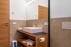 a bathroom with a sink and a mirror at Ferienwohnungen Karin - Cabernet in Termeno +21 photos
