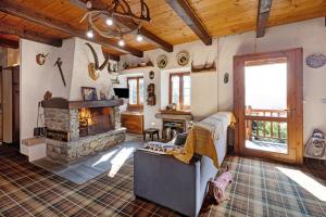 a living room with a couch and a fireplace at Al Pinone in Crevoladossola