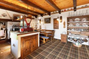 a large kitchen with a counter and a table at Al Pinone in Crevoladossola