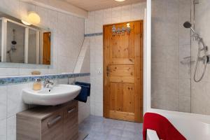a bathroom with a sink and a tub and a shower at Fewo Naturliebe - keine Monteure in Dornhan +16 photos