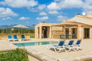 a group of chairs sitting next to a swimming pool at Sa Caseta Biniali in Biniali
