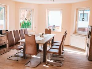 a dining room with a table and chairs at Ferienhaus Paula in Olsberg