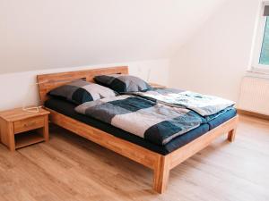 a wooden bed in a room with a wooden floor at Ferienhaus Paula in Olsberg