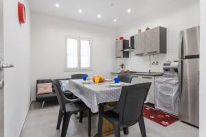 a kitchen with a table and chairs in a kitchen at Villa Mare Blu in Palermo +18 photos
