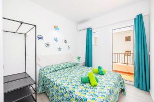 a bedroom with a bed with green pillows and a mirror at Gran Sol Family 6 in Felanitx +28 photos