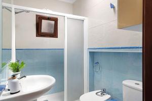 a bathroom with a sink and a toilet at Casa Playa Palmeras in Puerto del Carmen +20 photos