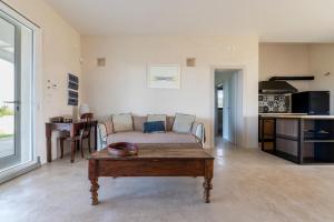 a living room with a couch and a coffee table at Casale 50 Elegante Villa a Otranto in Otranto