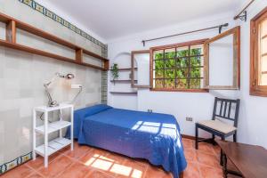 a bedroom with a bed and a desk and a chair at Villa Beach Palmitos in Can Picafort +30 photos