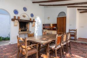 a dining room with a wooden table and chairs at Villa Beach Palmitos in Can Picafort