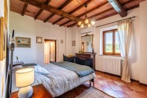 a bedroom with a bed and a window at Pietraserena - San Gimignano in San Gimignano +42 photos