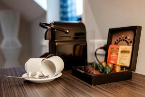 a coffee maker and a tray with dishes on a table at Hotel Derlon in Maastricht