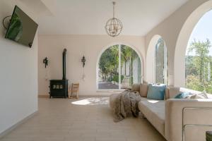 a living room with a couch and a fireplace at Finca Colica in Cómpeta
